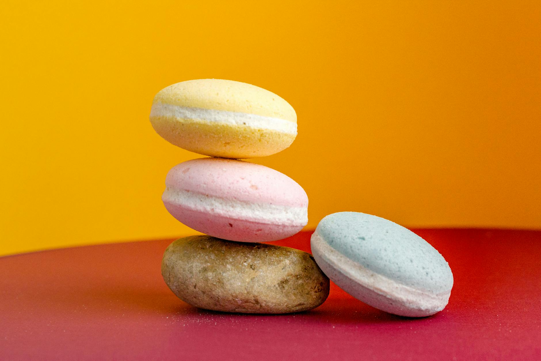 Creative composition of bath bombs and stone on table