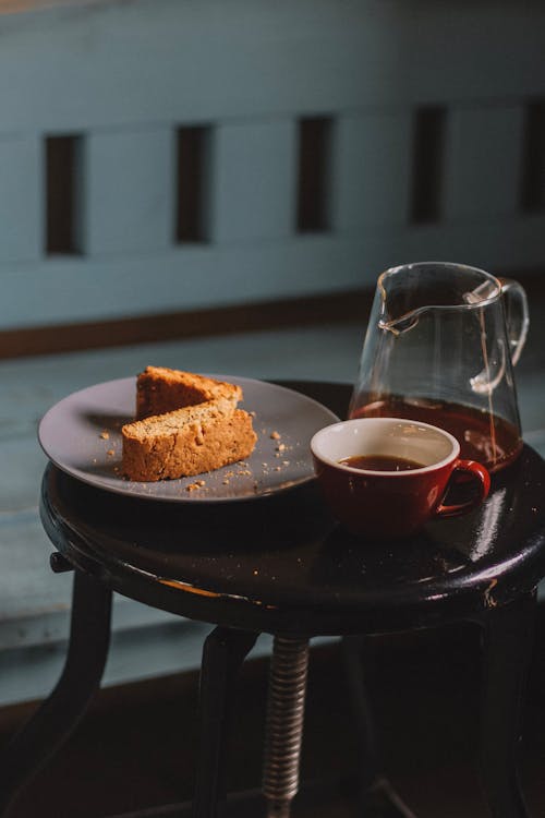 Delicious sweet cake served with tea in glass kettle