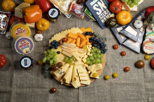 Colorful charcuterie board with assorted cheeses and fresh fruits.