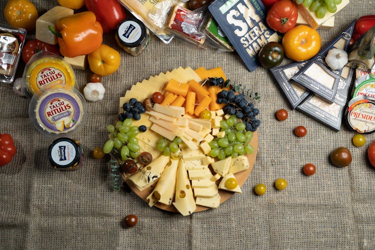 A Charcuterie Board With Cheese And Fruits