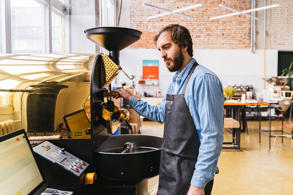 A Bearded Man Operating a Coffee Machine