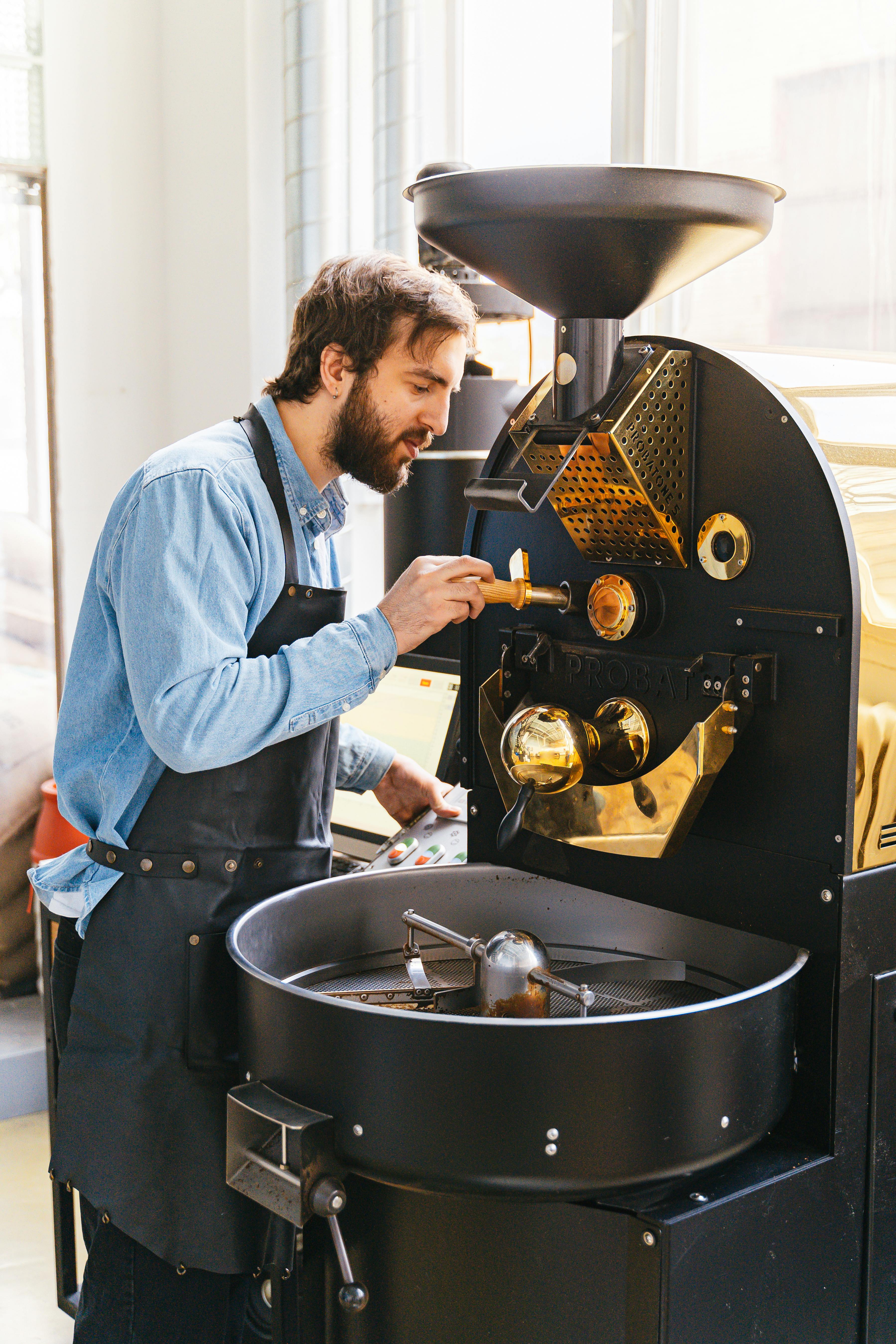 A Man Using a Coffee Roaster · Free Stock Photo