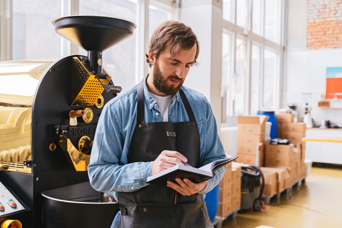 Man Holding a Notebook · Free Stock Photo