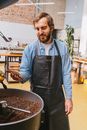 Man in Blue and White Long Sleeve Shirt Holding Black Cooking Pan
