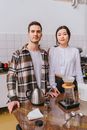 Man in White Crew Neck Shirt Beside Woman in Black and White Plaid Dress Shirt