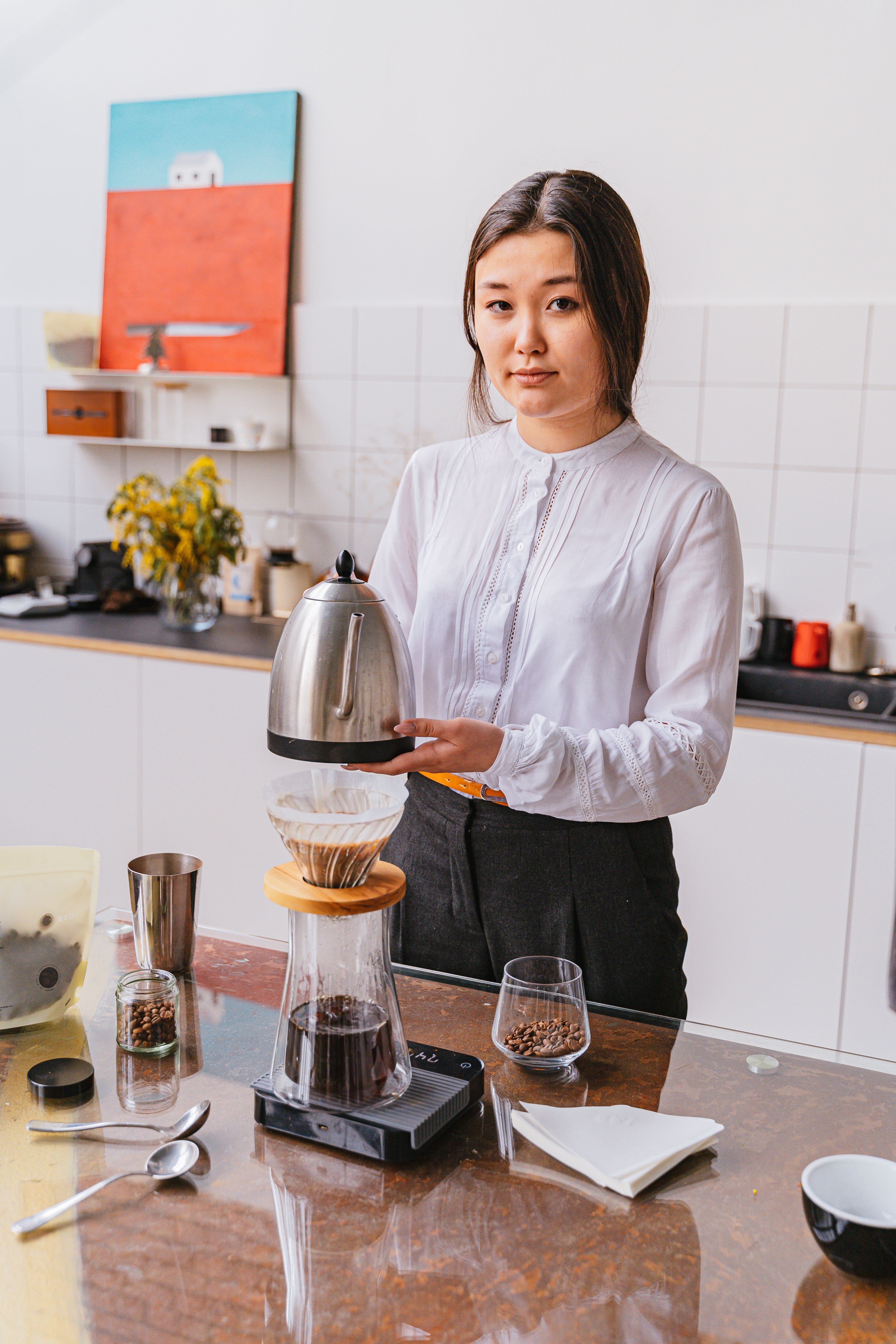 Woman in White Long Sleeves carrying an Electric Kettle · Free Stock Photo