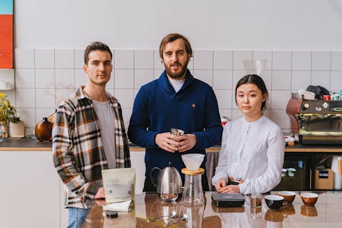 Portrait of Three People in a Kitchen with Coffee Making Equipment