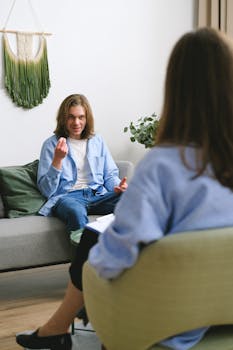 A modern psychotherapy session with a therapist and client in a comfortable office.