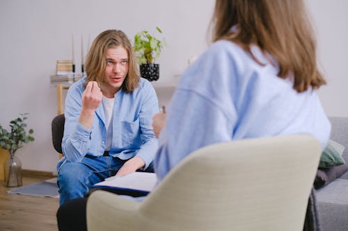 A Patient Gesturing and Talking to His Therapist