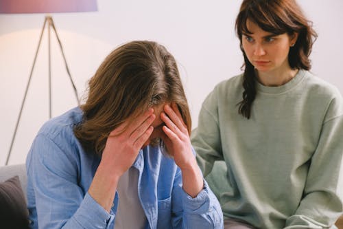 Disappointed woman looking at sorrowful man