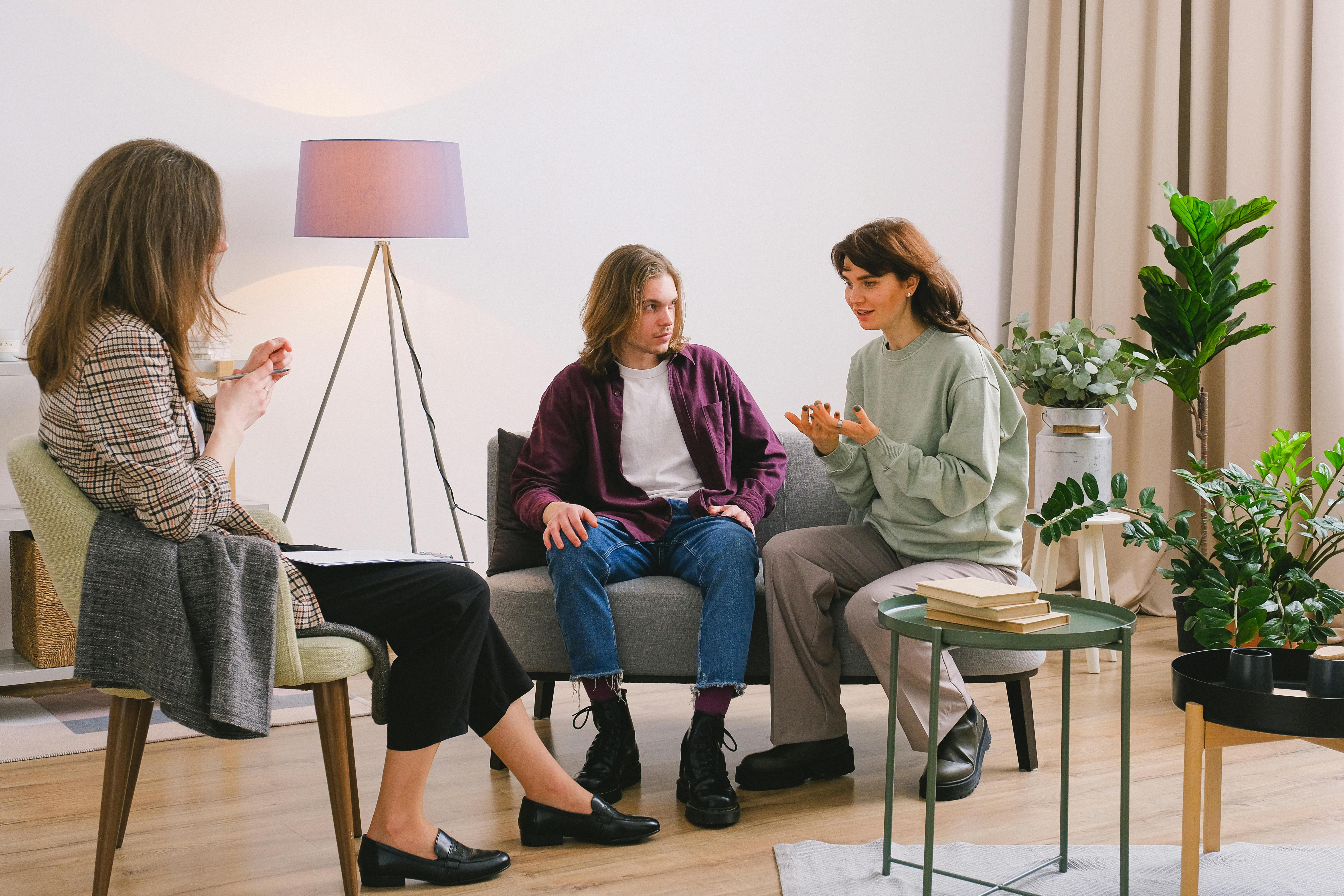 couple talking with psychologist in light room