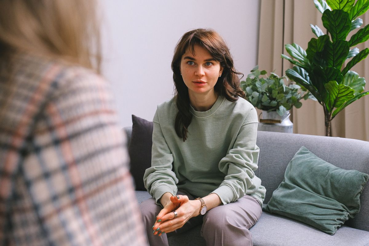 Group therapy session with diverse participants in supportive circle