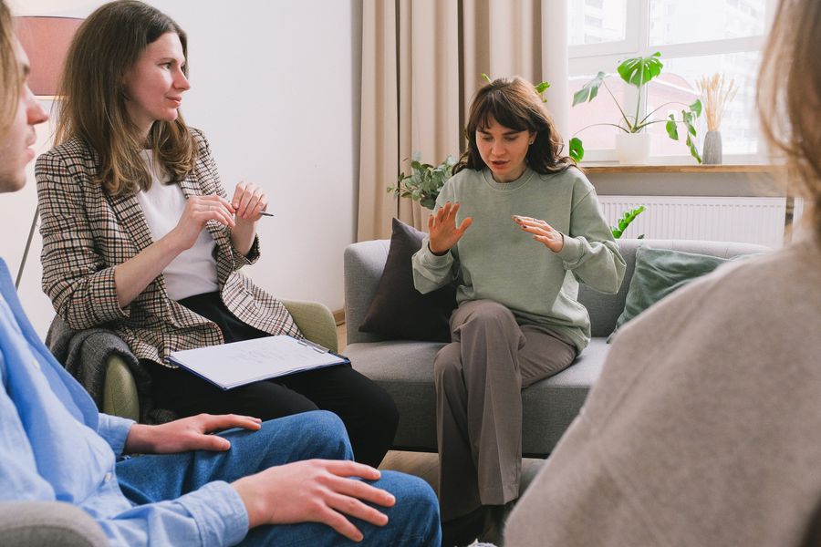 Counselor welcoming a client into a calm therapy room