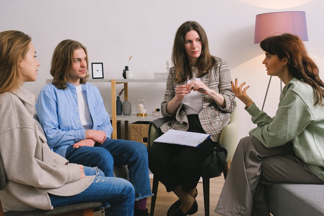 Free Woman discussing problem during group therapy Stock Photo