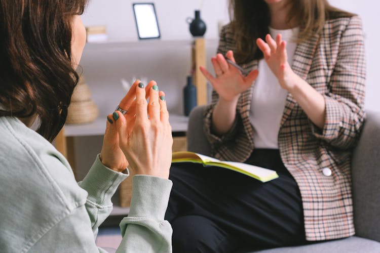 Crop Unrecognizable Female Psychologist And Patient Discussing Mental Problems During Session