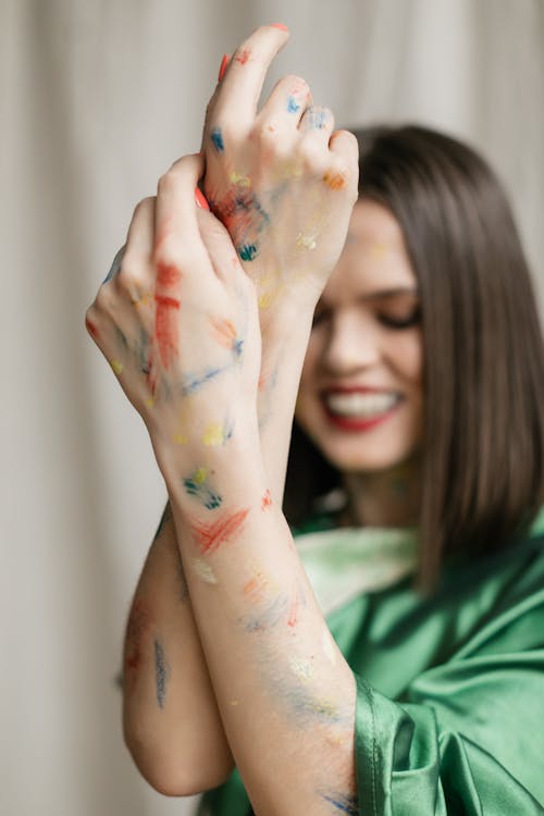 Woman Holding Painted Hands Together 
