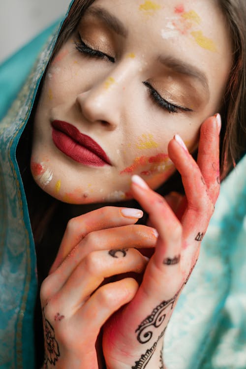 Free Close-Up Shot of Woman with Yellow and Orange Face Paint Stock Photo