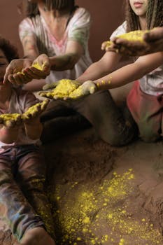 Children celebrating Holi with colorful powder in their hands, showcasing joy and festivity.
