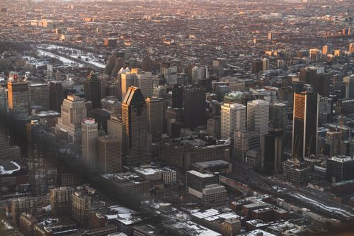 Free Discover Montreal's bustling skyline with this stunning aerial view capturing modern architecture at sunset. Stock Photo