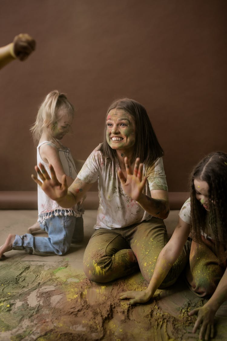 Woman And Girls Playing With Powder Paint