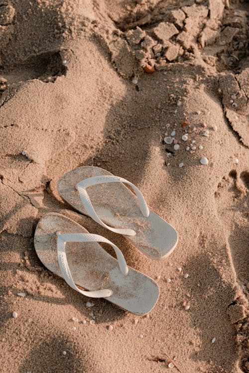 A Pair of Flip Flops on the Sand 