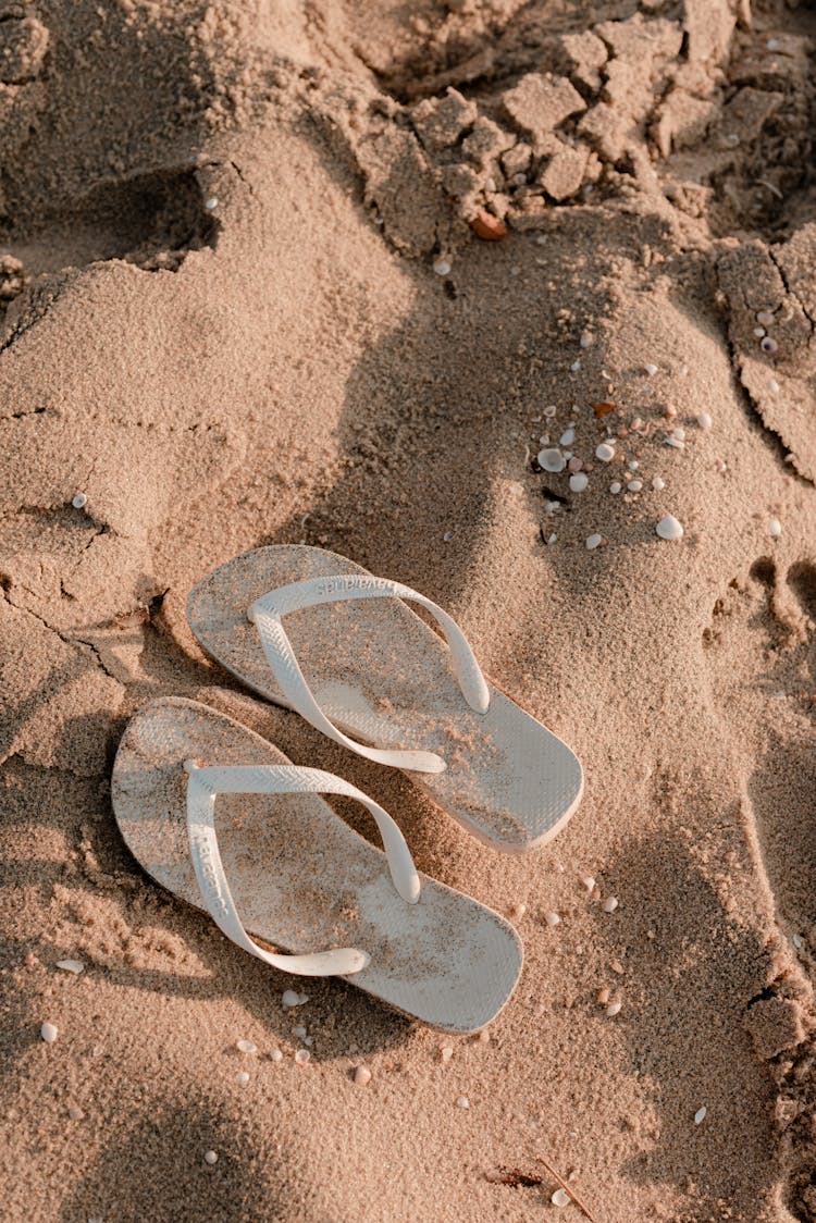 A Pair Of Flip Flops On The Sand 