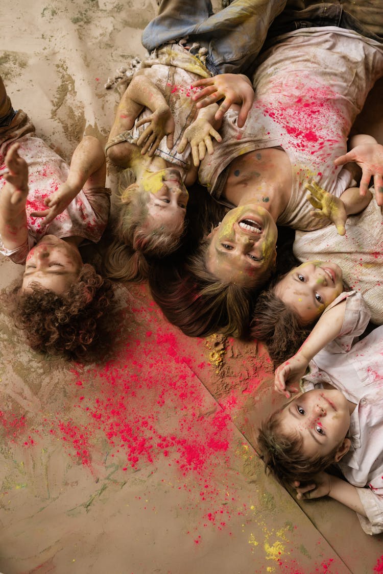 Overhead Shot Of A Woman And Kids With Holi Powder