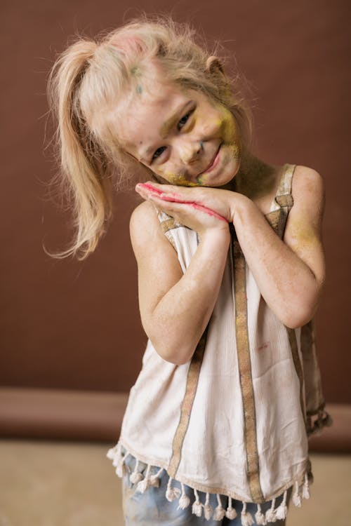Cute Little Girl with Colored Powder on Face