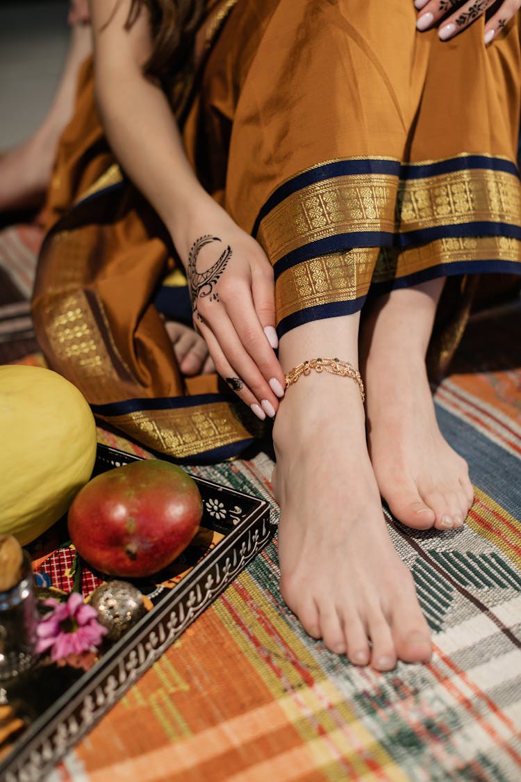 Close Up Of Womans Feet With Bracelet On A Rug