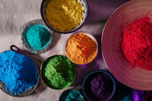 Free Colorful Holi festival powders in various bowls on a flat surface from above. Stock Photo
