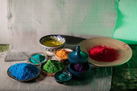 Vibrant Holi powders in various colors displayed in decorative bowls for festive celebrations.