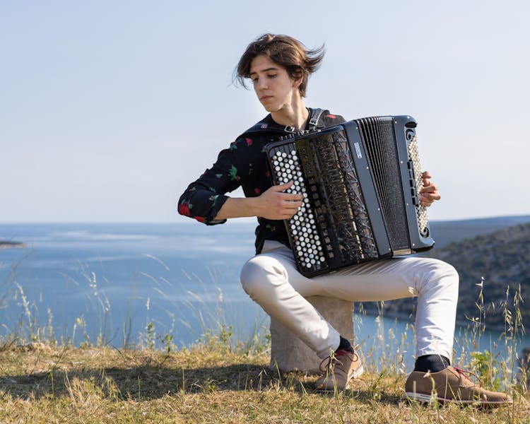 A Man Playing A Button Accordion