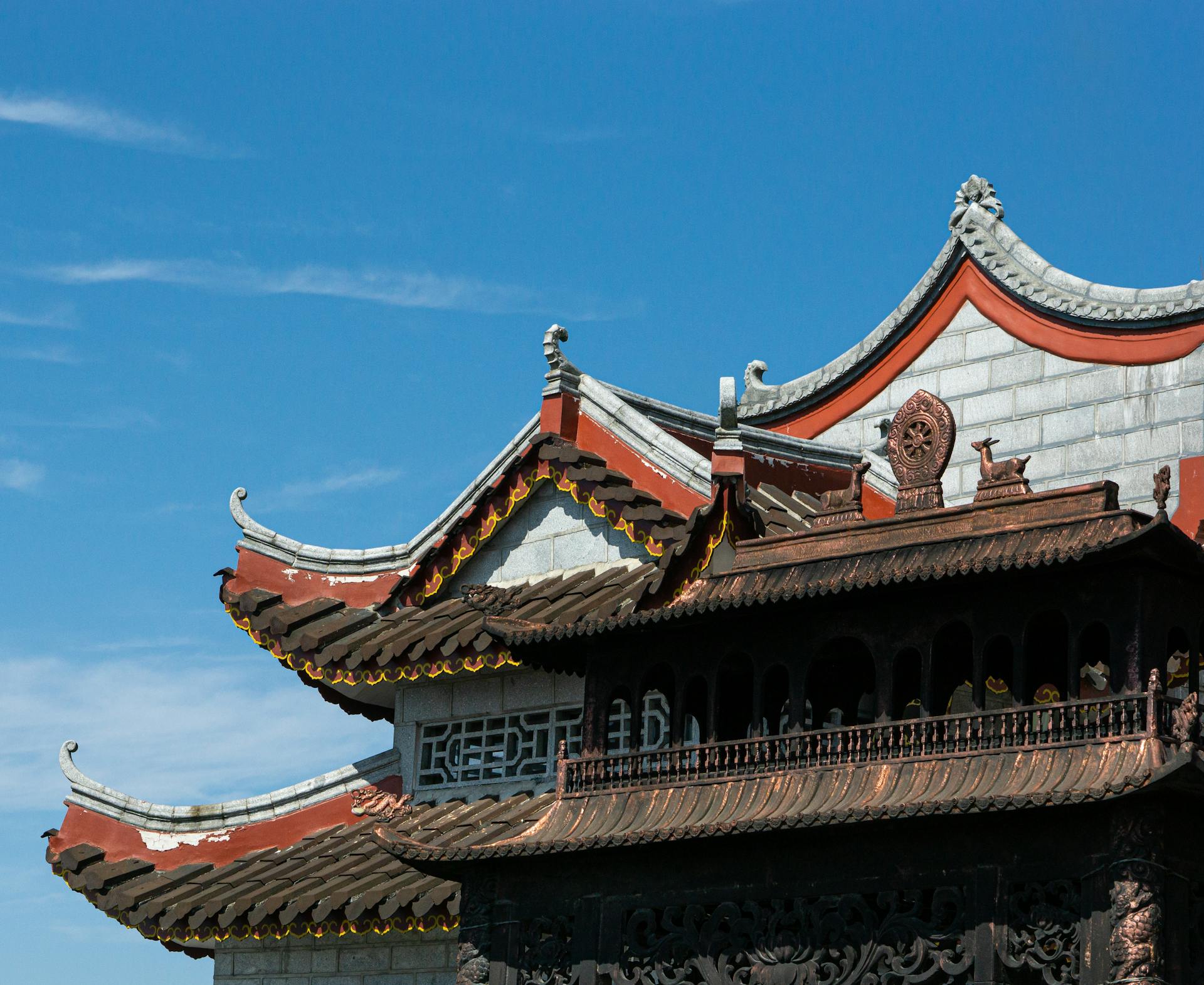 A stunning view of traditional Chinese architecture with intricate eaves against a clear blue sky.