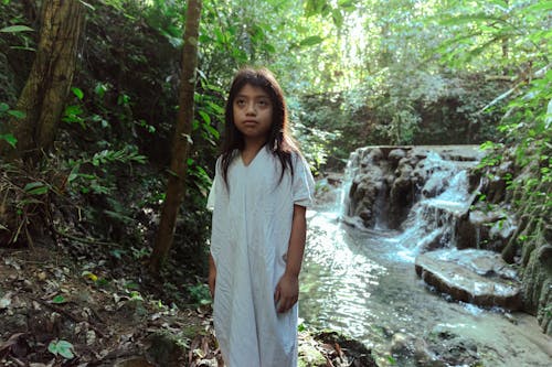 Free Photo Of Girl Standing Beside Flowing Stream  Stock Photo
