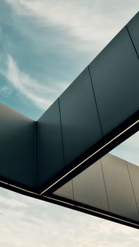 A futuristic architectural element with geometric shapes set against a blue sky, showcasing modern and minimalist design.