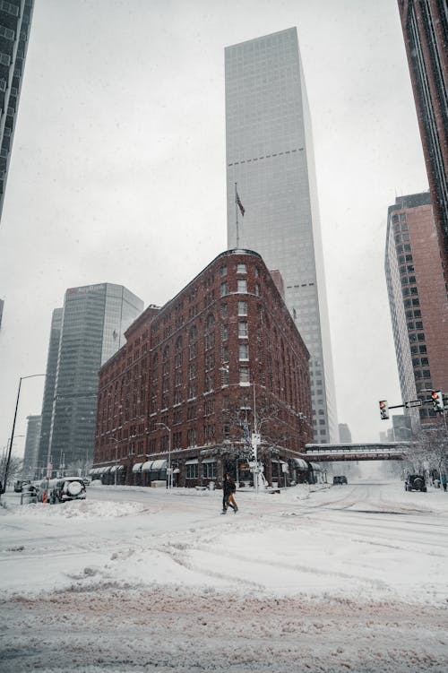 People Walking on the Street Near Tall Buildings During Winter