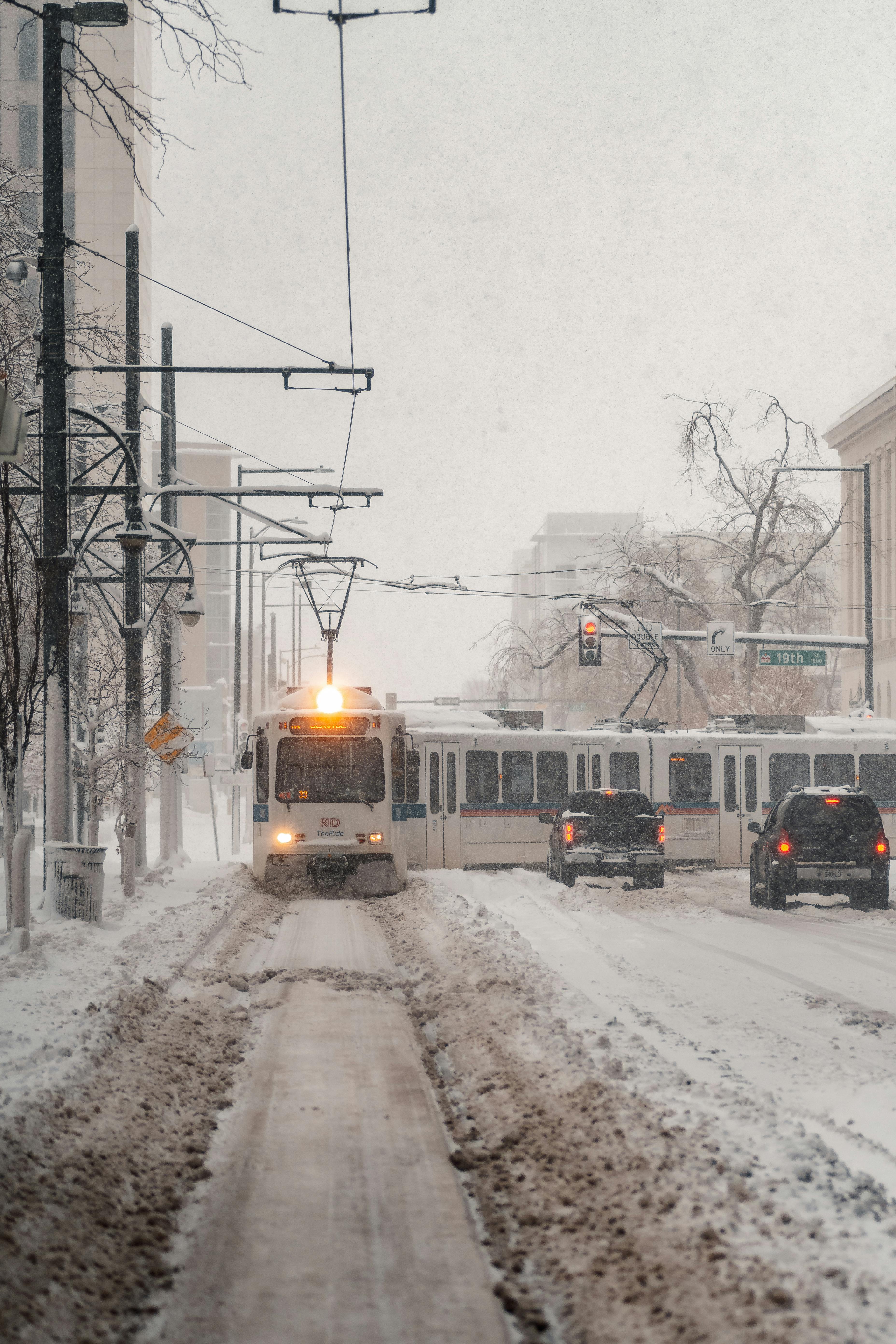 Tram in snow-covered street during winter in Denver, Colorado. Urban winter scene.