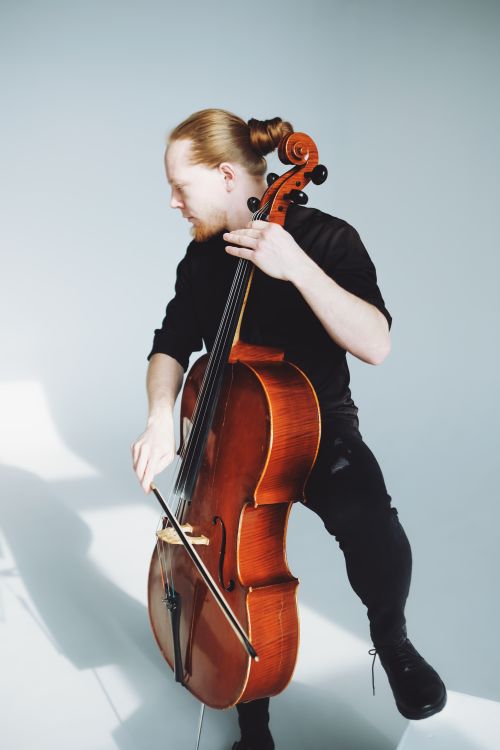 Free A cellist passionately playing the cello in a minimalist indoor studio. Stock Photo