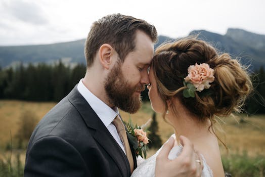 Tender moment of newlyweds embracing amidst beautiful mountain scenery.