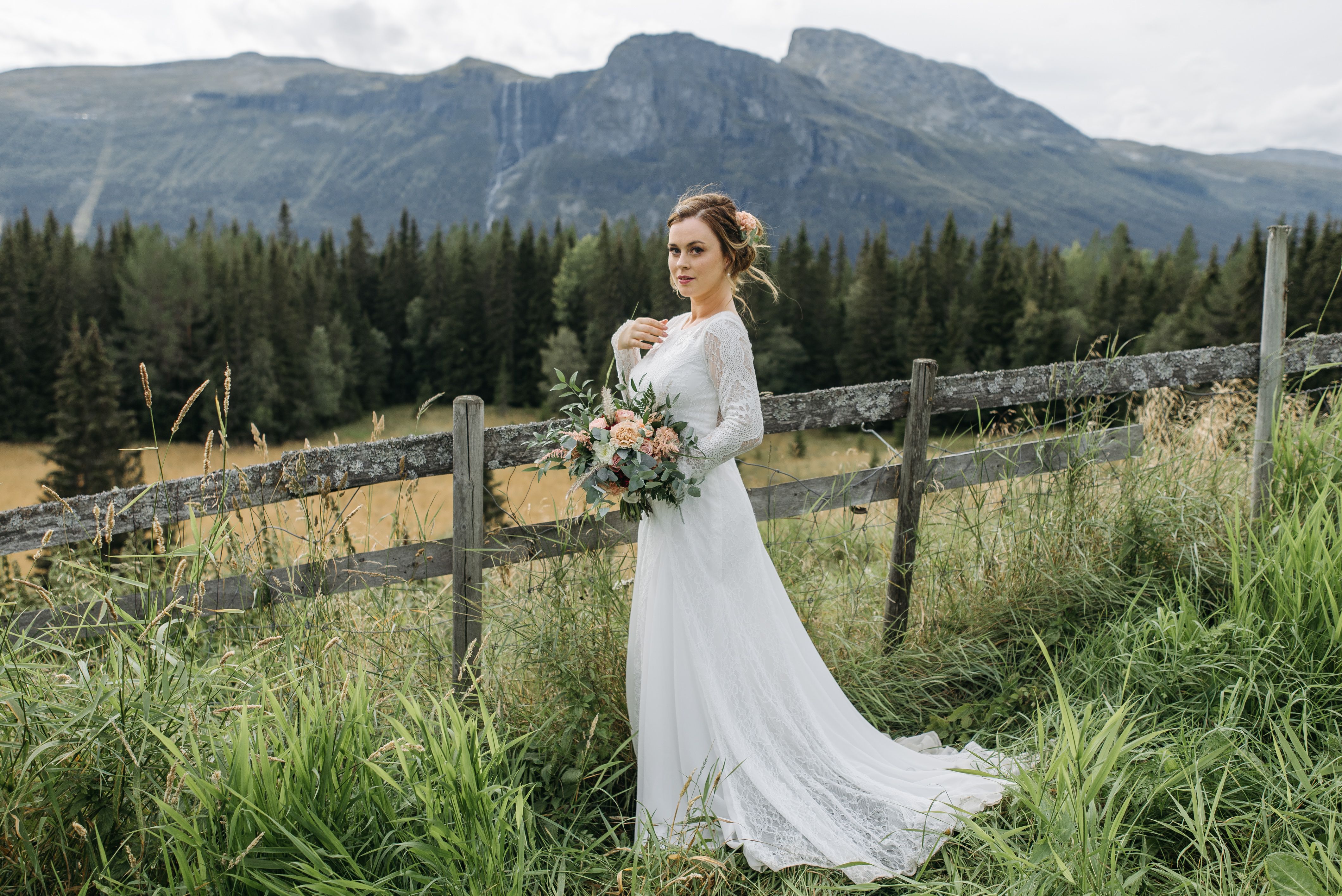 A Woman in a Wedding Dress Holding a Bouquet of Flowers · Free Stock Photo