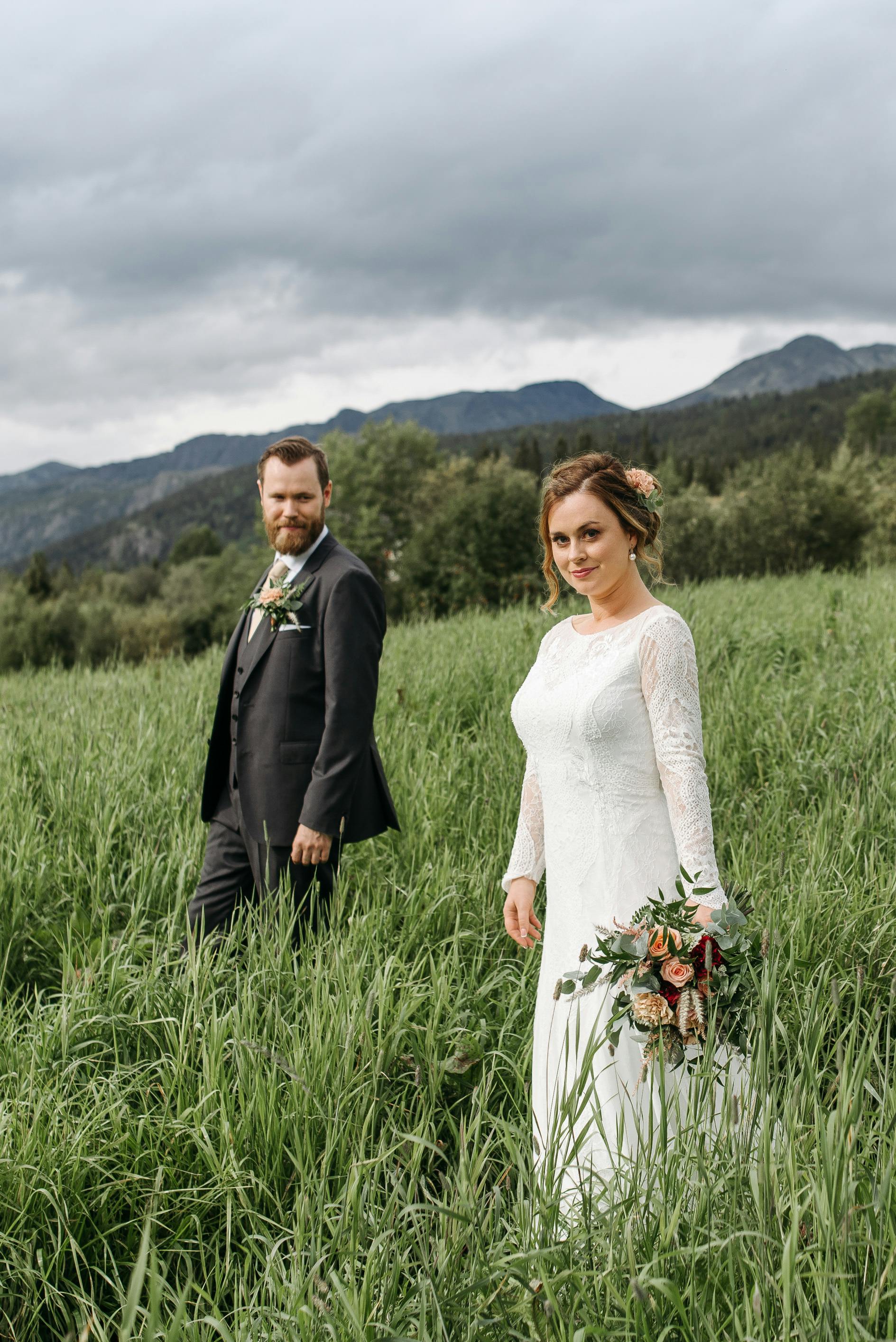 newlyweds walking on grass