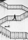 Grayscale Photo of a Man Wearing Face Mask Walking Up the Staircase