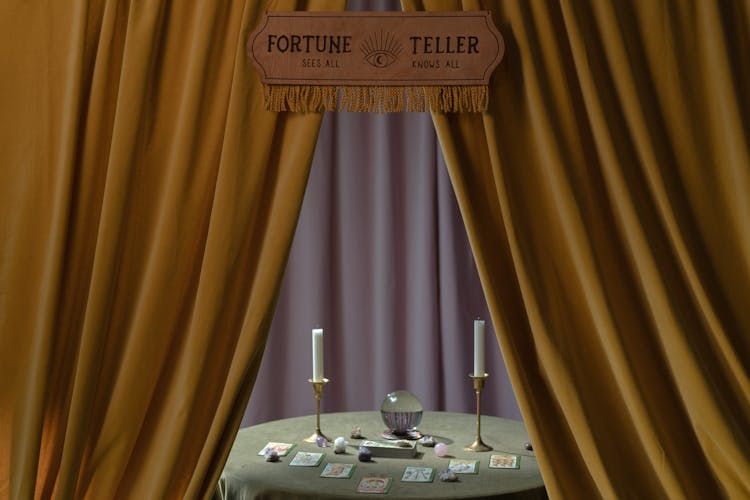 A Fortune Teller Booth With A Table Full Of Fortune Telling Tools