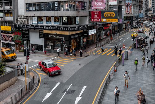 Free A high-angle view of a lively urban intersection filled with pedestrians and traffic. Stock Photo