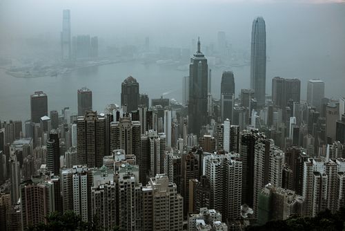Free Aerial view of Hong Kong's iconic skyscrapers shrouded in fog over Victoria Harbour. Stock Photo