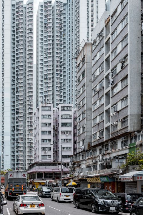 Free Lively city street surrounded by towering skyscrapers and vehicles in a vibrant urban setting. Stock Photo