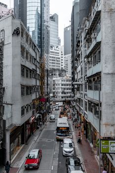 Busy urban street captured from a high angle. Skyscrapers and bustling street life.