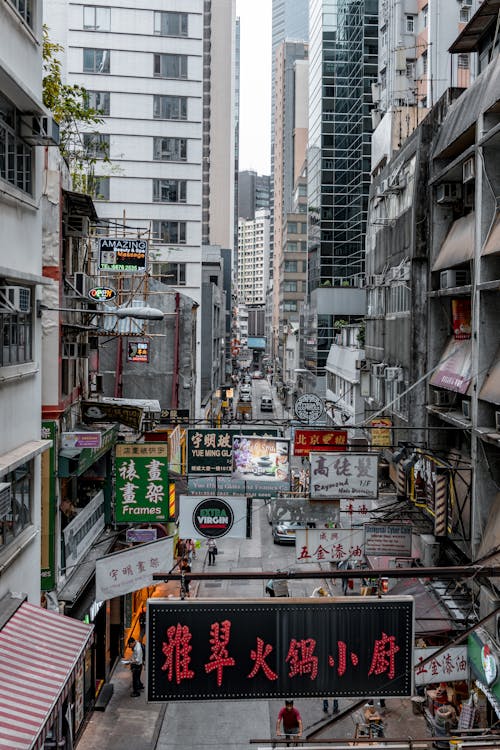 A City Street  with Hanging Signages Between High Rise Buildings