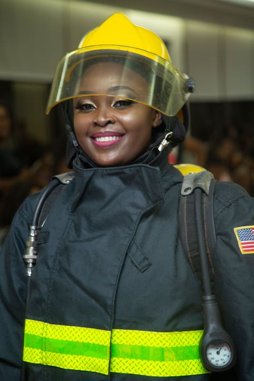A Woman in Black Uniform Wearing Yellow Helmet