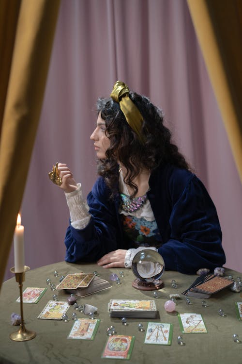 Woman Sitting at the Table with Tarot Cards